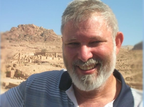 The photo of a smiling man in an arid mountainous landscape is accompanied by the title, Eli Meiri, Accessible tour guide in Israel.