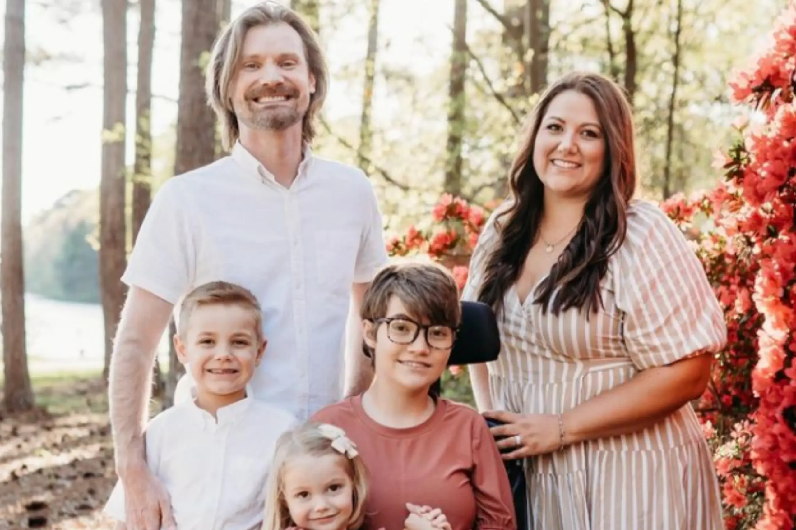 A man, woman and three kids stand smiling outside with sun-dappled trees and vibrant pink flowers behind them. The headline reads, Why we prioritize travel, by Behtany Hildebrandt. Read More.