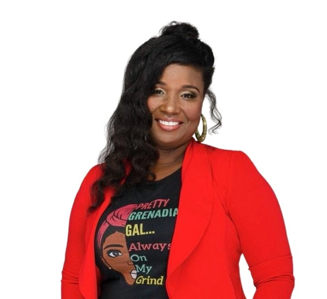 A waist-up portrait of a smiling woman with dark hair styled partially up, wearing a bright red blazer over a black t-shirt that features a graphic and text reading "PRETTY GRENADIA GAL... Always On My Grind." The background is plain white.