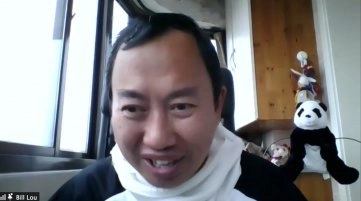 A screenshot from a video call showing a smiling, middle-aged East Asian man wearing what appears to be a panda-themed hooded sweatshirt, or a black shirt with a white hood. The man is looking directly at the camera. In the background, a large panda stuffed animal and smaller dolls are visible on a shelf to the right. The name "Bill Lou" is visible in the lower left corner.