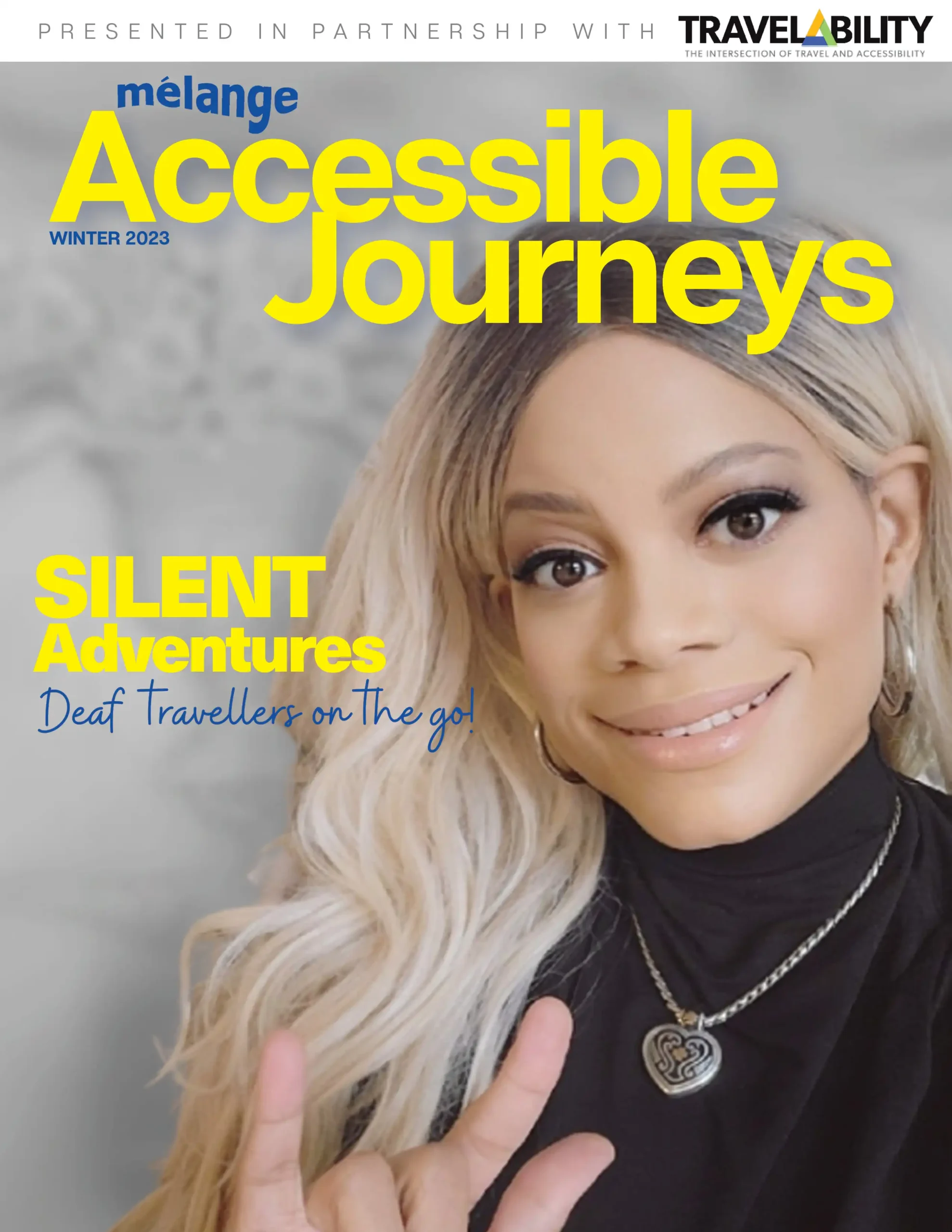 Cover of Mélange Accessible Journeys magazine, January 2024 edition. The cover features a smiling woman with long blonde hair, wearing a black turtleneck and a heart-shaped necklace. She is making the sign for 'I love you' in American Sign Language. The title reads 'SILENT Adventures: Deaf Travellers on the go!' Presented in partnership with TravelAbility