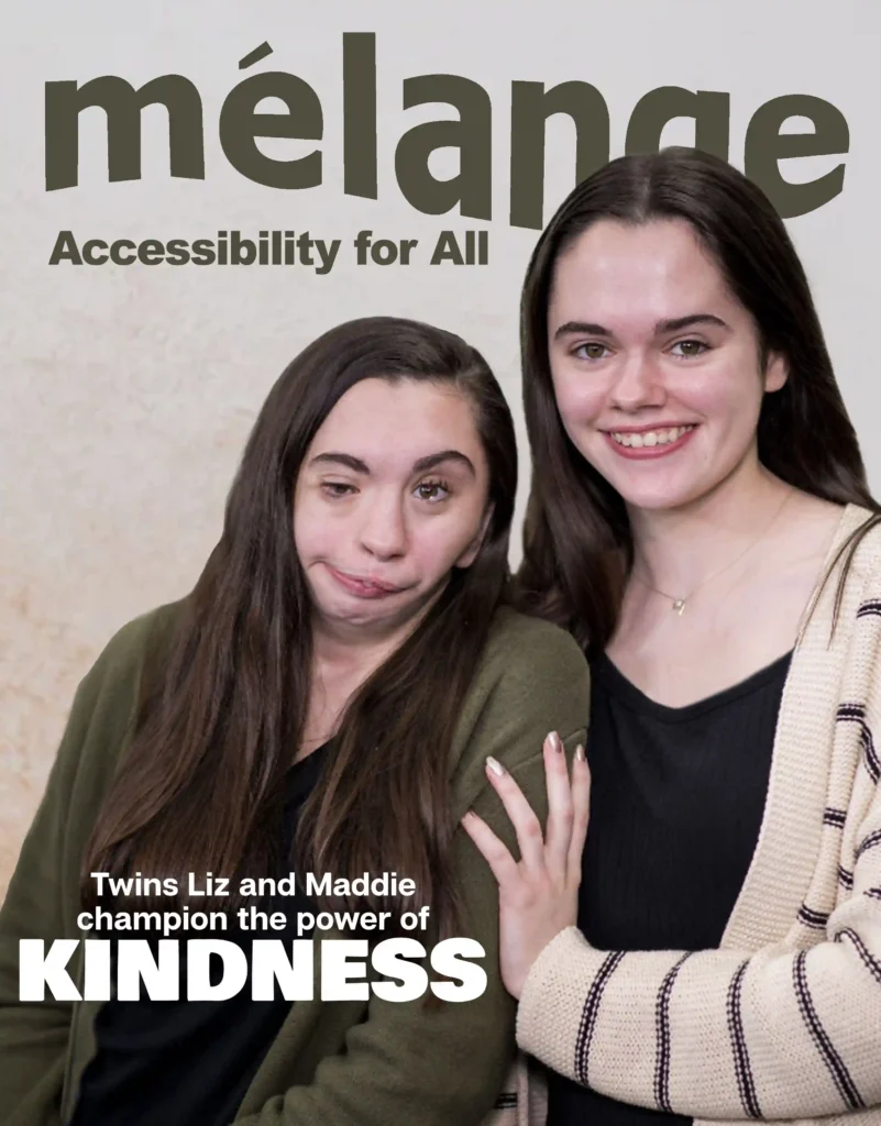 Cover of Mélange magazine with the headline 'Accessibility for All.' Below, there is a photo of twin sisters Liz and Maddie. Liz, on the left, has a facial difference, while Maddie, on the right, smiles warmly. Both are wearing casual cardigans. The subheading reads, 'Twins Liz and Maddie champion the power of KINDNESS