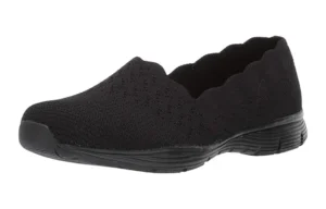 Black slip-on shoe with a textured pattern and scalloped edge, designed for comfort and casual wear.