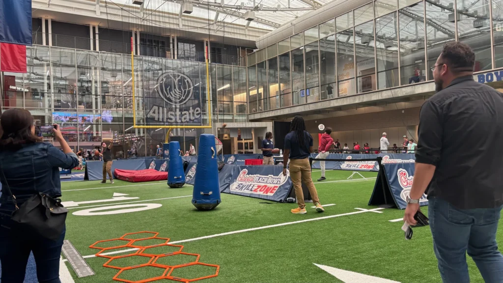 People participate in a Chick-fil-A Peach Bowl Skill Zone, throwing footballs. Allstate logo visible.