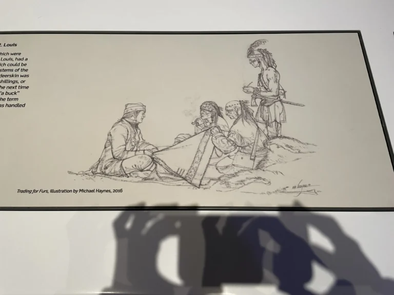 Illustration depicting a fur trading scene with four figures, including two Native American men and two European settlers, engaging in a transaction. The background suggests a natural setting, emphasizing the historical context of fur trading.
