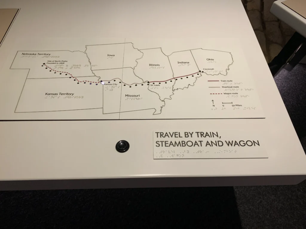 A map display shows routes through midwestern U.S. territories, labeled "Travel by Train, Steamboat and Wagon," with lines marking journey paths across several states.