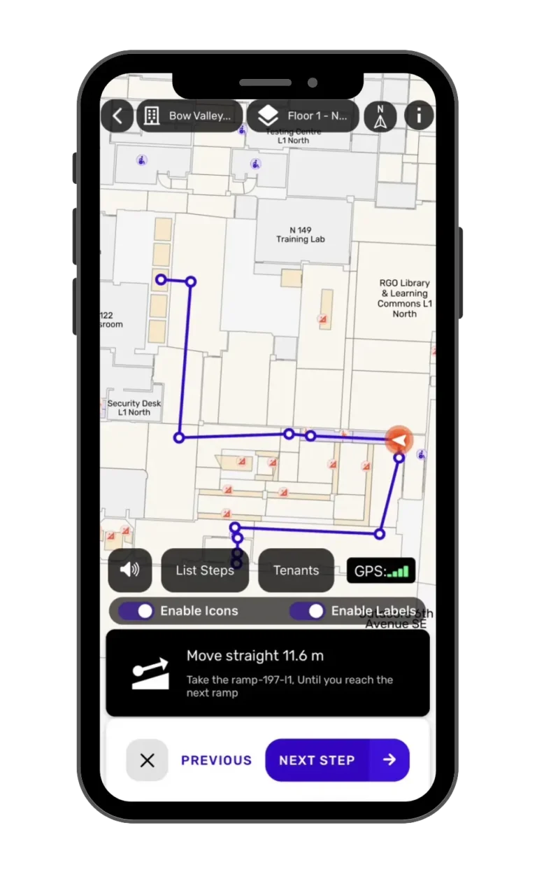 Three smartphones are displayed. The center screen shows an indoor navigation map with directions, icons, and labels. The left screen displays a solid orange background, and the right screen shows a partial app login screen with a circular logo.