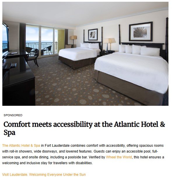 A spacious hotel room at the Atlantic Hotel & Spa in Fort Lauderdale featuring two large beds with white linens, a desk and chair, a flat-screen TV, and a balcony with an ocean view. The room is designed with accessibility in mind, offering ample space and comfort.