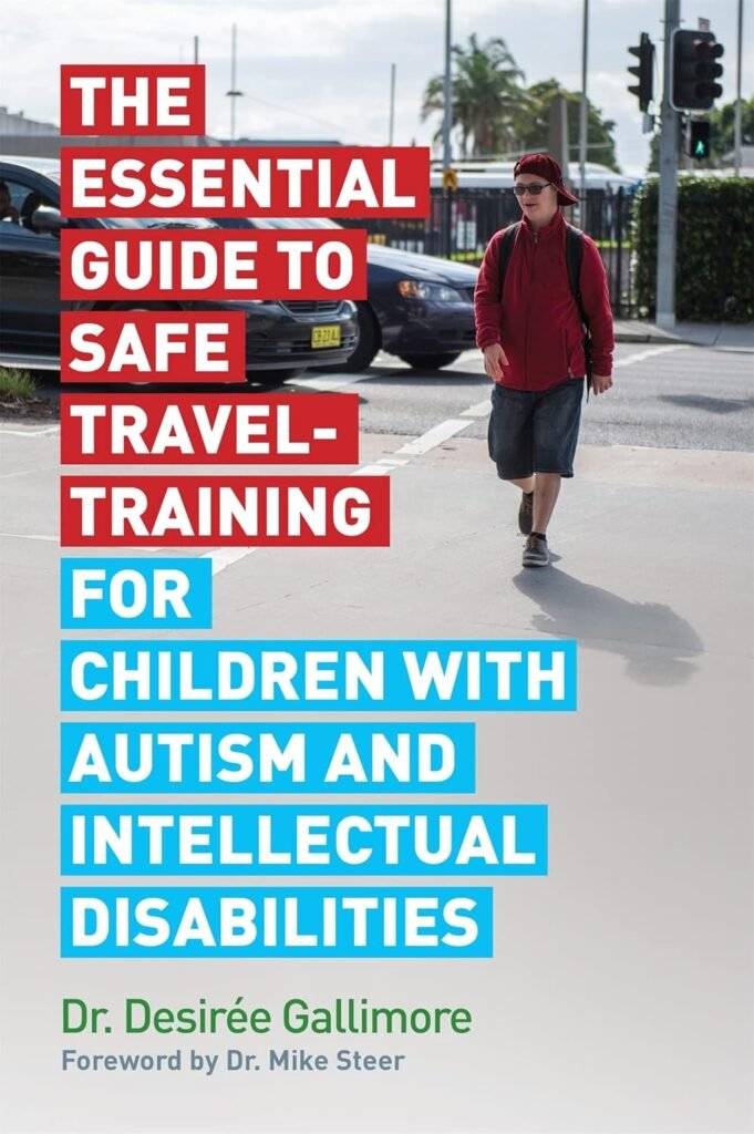 A book cover featuring a young man with a red baseball cap and red jacket walking across a crosswalk in an urban area. The title is in large, bold, two-toned boxes. The words "THE ESSENTIAL GUIDE TO SAFE TRAVEL-TRAINING FOR" are in red boxes, while "CHILDREN WITH AUTISM AND INTELLECTUAL DISABILITIES" are in blue boxes.