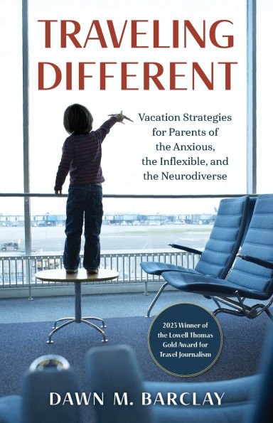 A book cover showing a child's back as they stand on a table at an airport, looking out a large window at a plane and runway. The child is holding a small toy airplane and pointing toward the window. Two empty airport lounge chairs are in the foreground on the right. The title "TRAVELING DIFFERENT" is in large, red text at the top. The subtitle "Vacation Strategies for Parents of the Anxious, the Inflexible, and the Neurodiverse" is below the title
