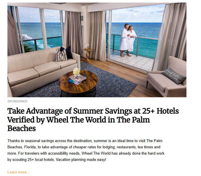 A couple in white robes stands on the balcony of a bright hotel suite, looking out at the vast ocean. The hotel room has a sofa, a coffee table, and a view of the balcony.