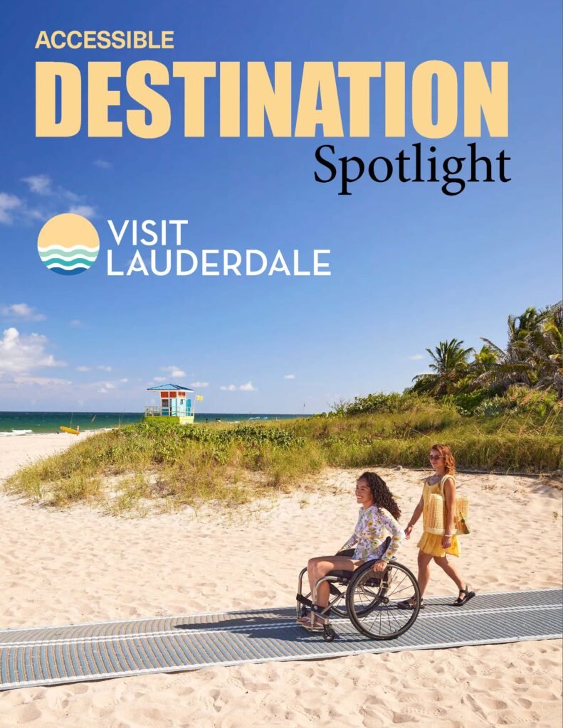 Two women enjoy a beach day on an accessible path, with a lifeguard tower and the ocean in the background under a clear blue sky.