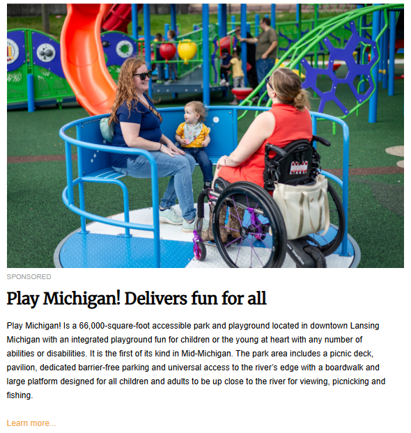 An aerial view of a playground shows two adults, one in a wheelchair, and a child on a spinning platform. Other children and adults are visible in the background, which includes colorful playground equipment and green turf.