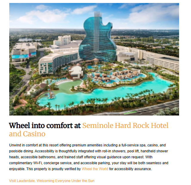 An aerial view of a hotel and casino complex shaped like a guitar. The building is surrounded by a large swimming pool with palm trees, with other buildings and a city in the background.