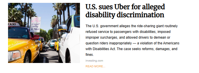 A news photo showing a street full of traffic. In the background, someone is holding a sign that says, "A lawsuit w/ Uber for disability rights," referencing the U.S. government's lawsuit against the company.