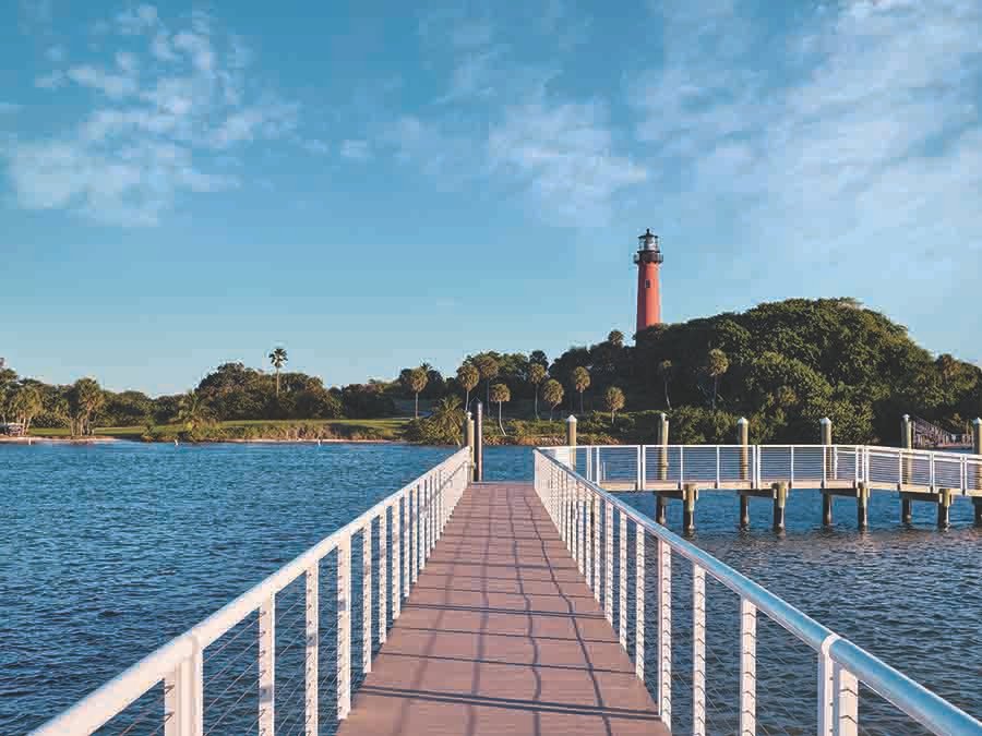 Scenic pier view of Jupiter Inlet Lighthouse in The Palm Beaches Florida vacation destination