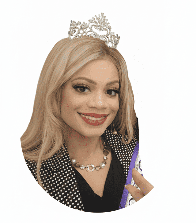 A circular portrait of a smiling woman with long blonde hair and a crown. She is wearing a black and white polka-dot blazer over a black top and a pearl/silver necklace. She is holding a purple sash with her right hand.