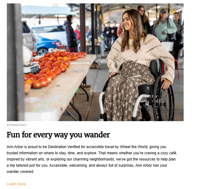 A sponsored content image featuring a young woman with long brown hair, sitting in a modern wheelchair, smiling happily at a bustling outdoor market. She is wearing a cream-colored sweater and a long floral skirt, and in the foreground is a table laden with bright red tomatoes. The text below reads: "Fun for every way you wander."
