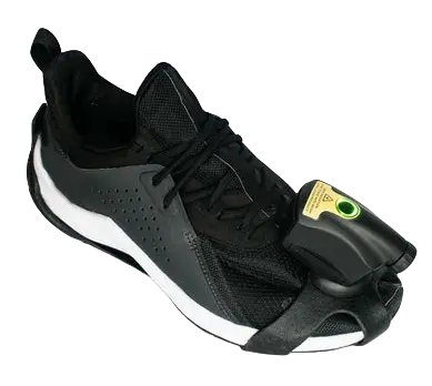 The Path Feel wearable device attached to the laces of a black athletic sneaker, featuring a green LED indicator for gait monitoring.