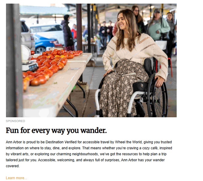 A "Sponsored" travel advertisement featuring a smiling woman in a wheelchair at an outdoor market. She is wearing a cream-colored sweater and a floral patterned skirt. Beside her is a table filled with fresh red tomatoes. The headline reads, "Fun for every way you wander," promoting Ann Arbor's accessible travel certification.