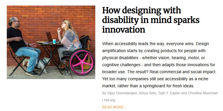 A business article titled "How designing with disability in mind sparks innovation." The photo shows a man and a woman sitting at an outdoor cafe table against a red brick wall; the woman is using a wheelchair with bright pink wheels and has a small white dog sitting under the table. The text argues that designing for people with physical or cognitive challenges leads to "design amplification" and commercial impact that benefits everyone.